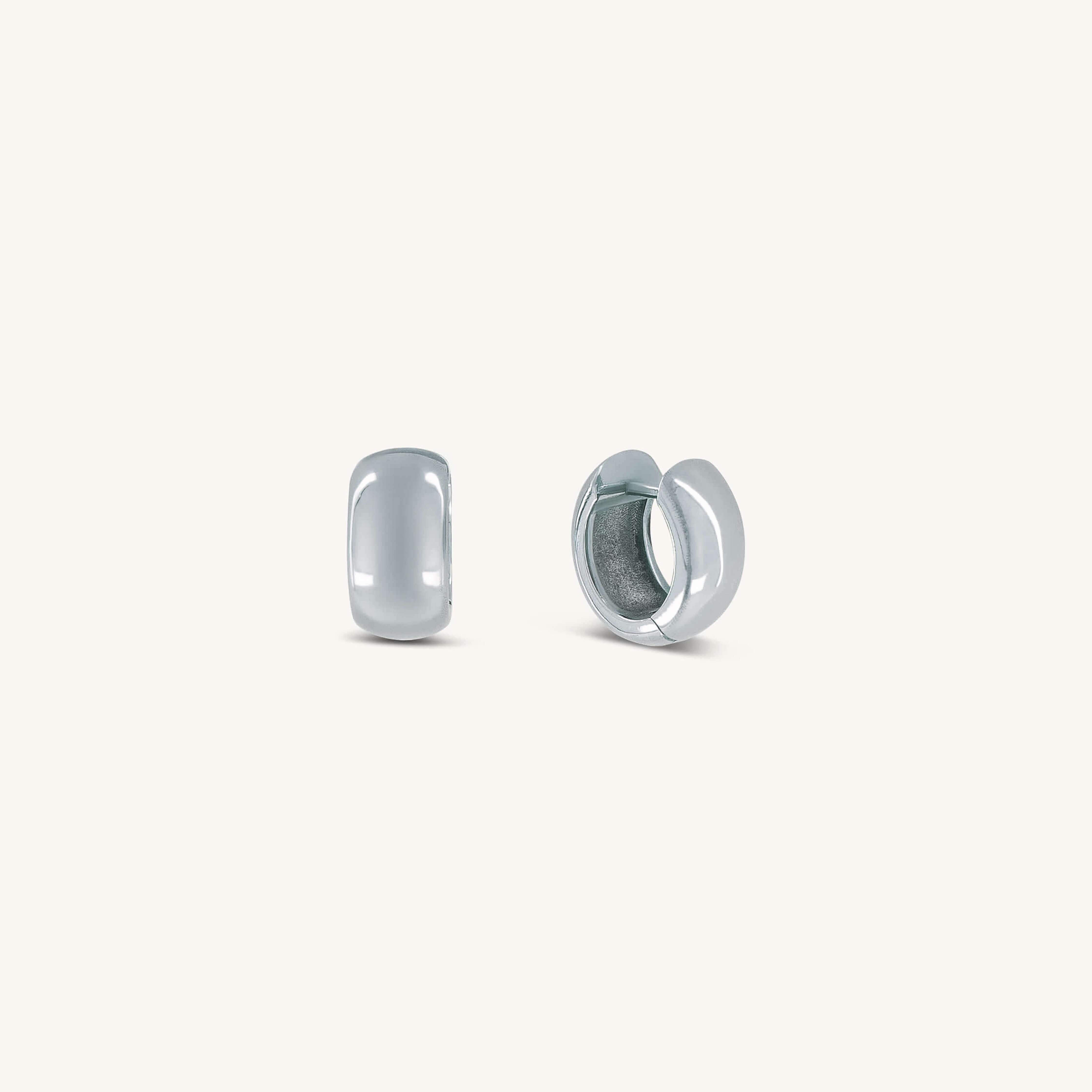 Pair of silver hoop earrings on a white background