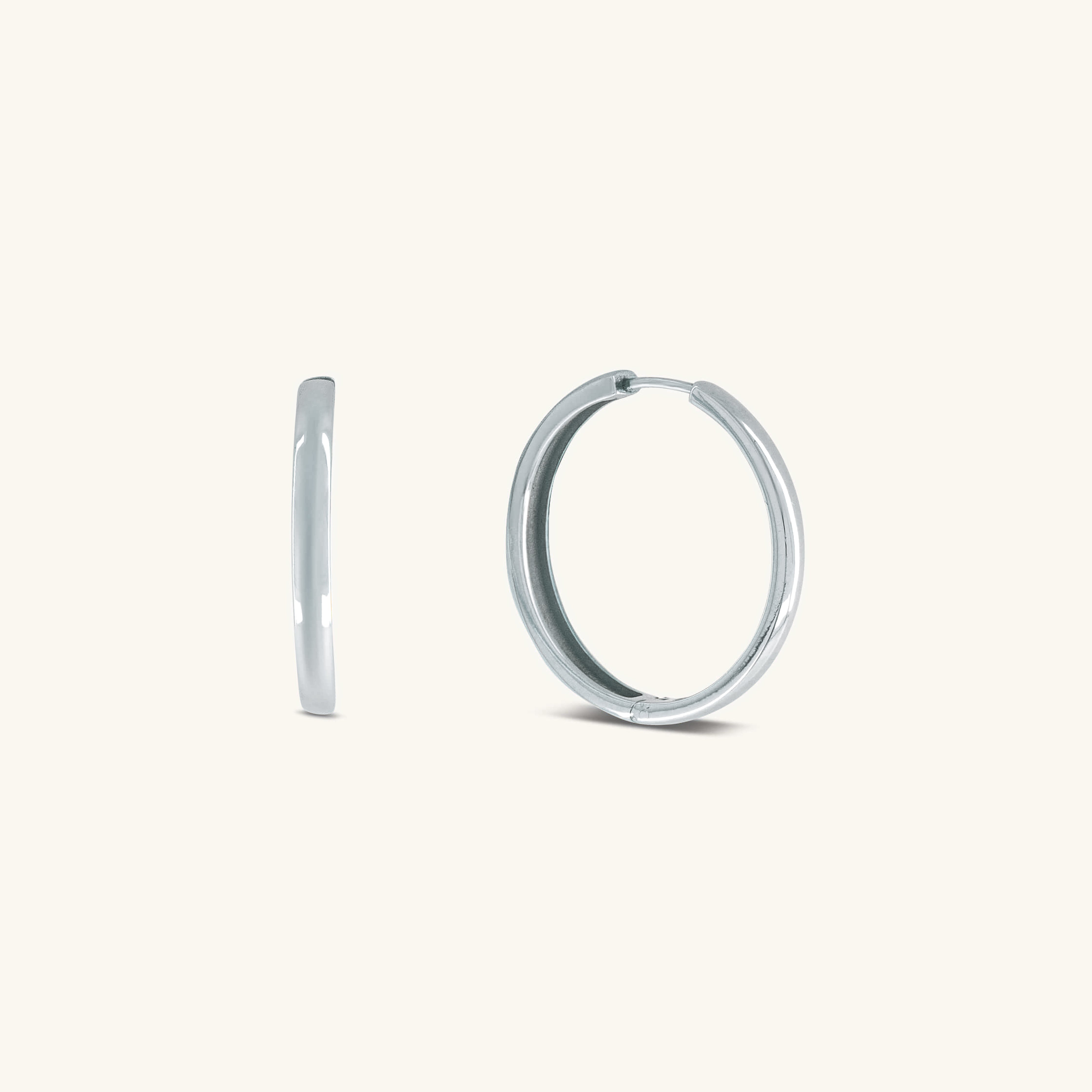 Silver hoop earrings on a white background