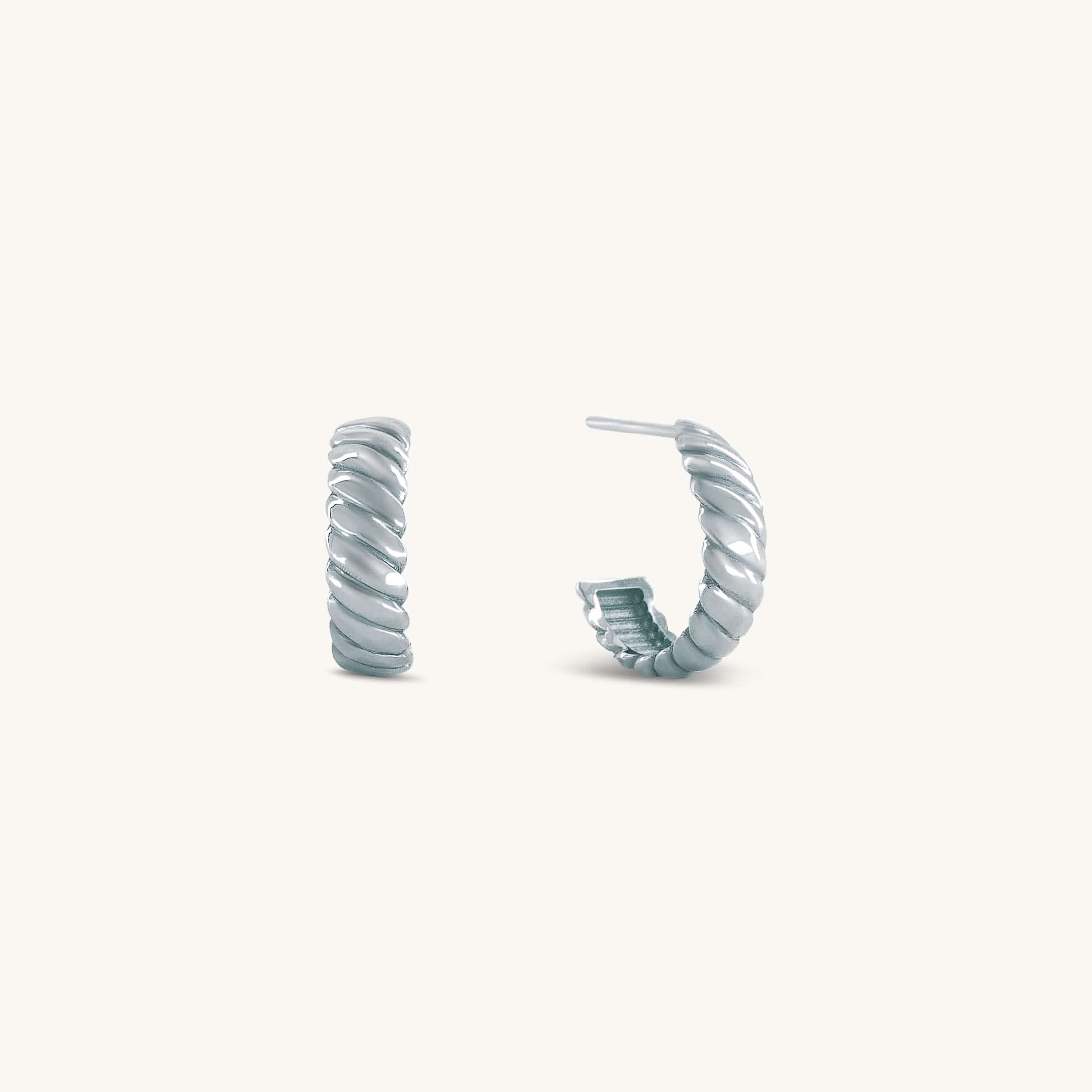 Pair of silver hoop earrings on a white background
