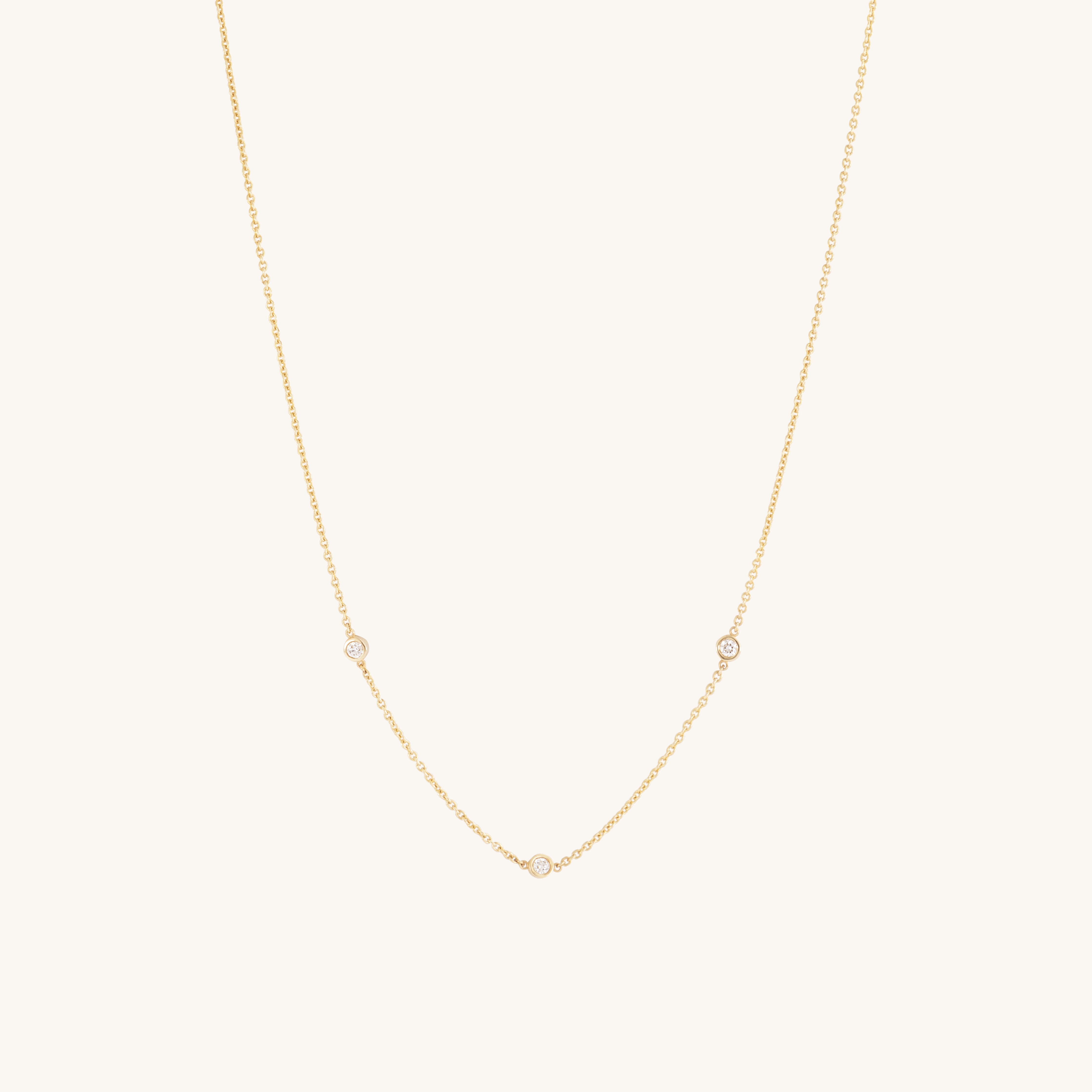 The Glasâje Satellite Necklace features 9ct solid gold with three small ethically-grown diamonds spaced along the lower chain, shown on a plain light background.