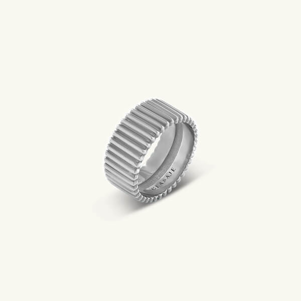 Silver ring with a textured design on a light gray background